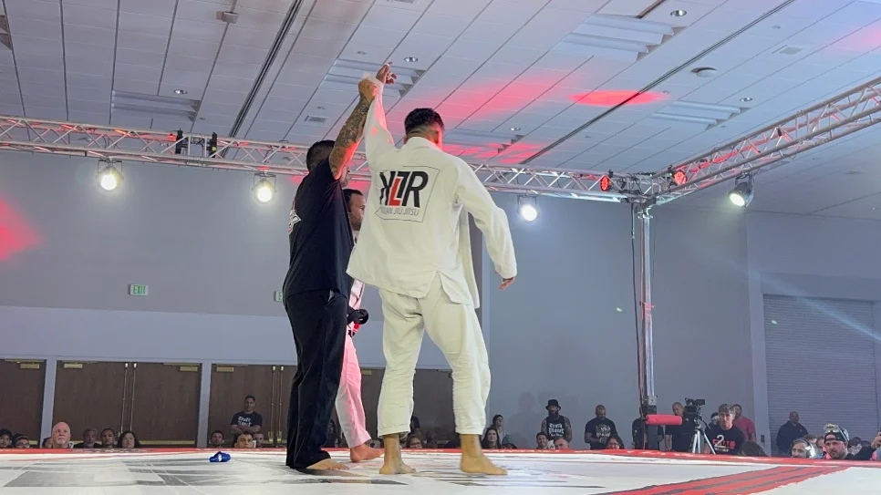 Kulture BJJ competitor with Professor Richard Lopez coaching from the side of the mat at a tournament