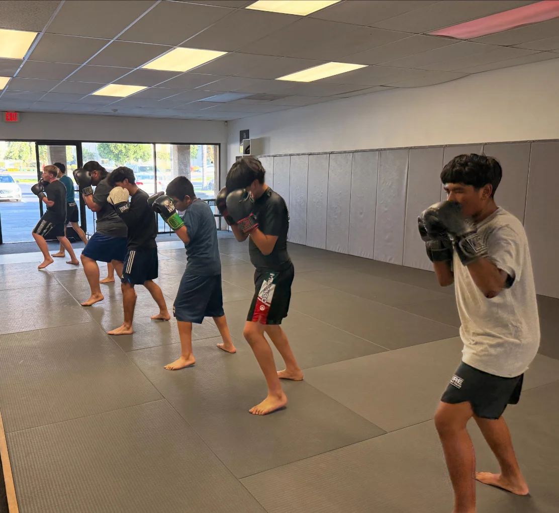 Youth boxing class practicing guard and footwork at Kulture BJJ